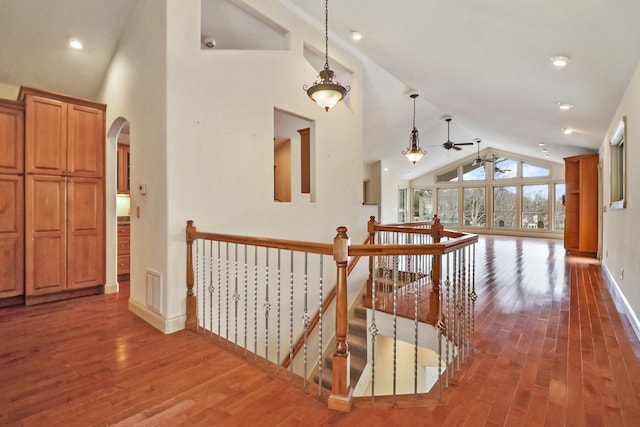 corridor featuring high vaulted ceiling and dark wood-type flooring