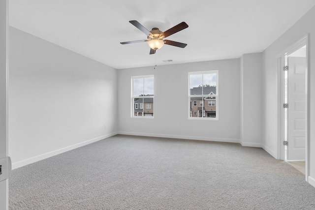 carpeted empty room featuring ceiling fan