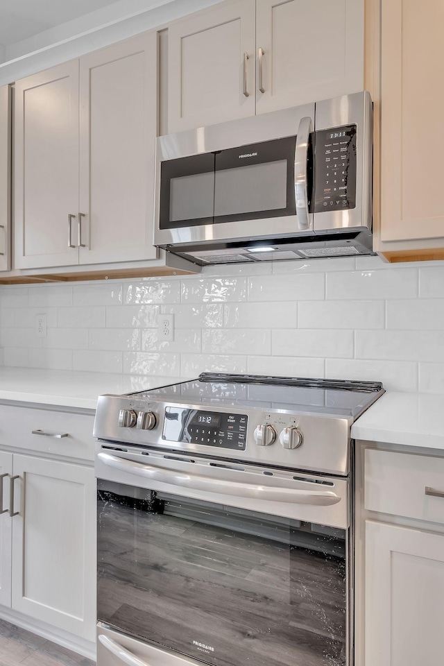 kitchen featuring stainless steel appliances and backsplash