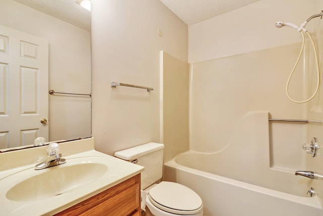 full bathroom featuring toilet, shower / washtub combination, a textured ceiling, and vanity