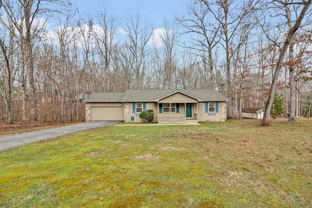 view of front of home with driveway, an attached garage, and a front lawn