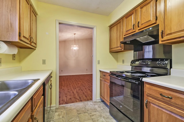 kitchen featuring brown cabinetry, black electric range oven, light countertops, under cabinet range hood, and pendant lighting