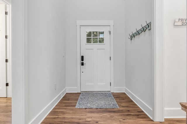 doorway with dark wood-type flooring