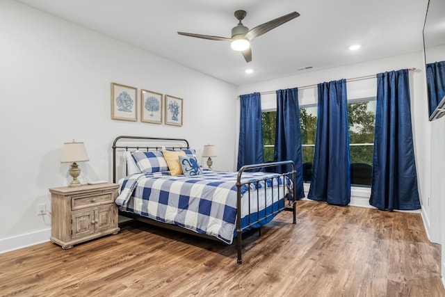 bedroom featuring light wood-type flooring and ceiling fan