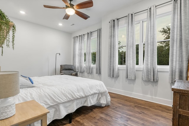 bedroom with ceiling fan and dark wood-type flooring