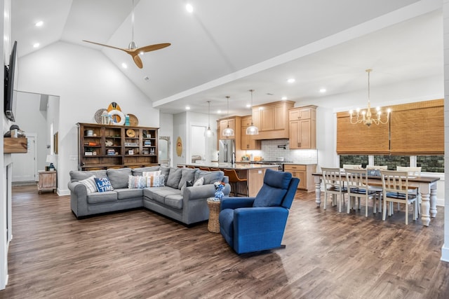 living room featuring ceiling fan with notable chandelier, high vaulted ceiling, and dark hardwood / wood-style flooring