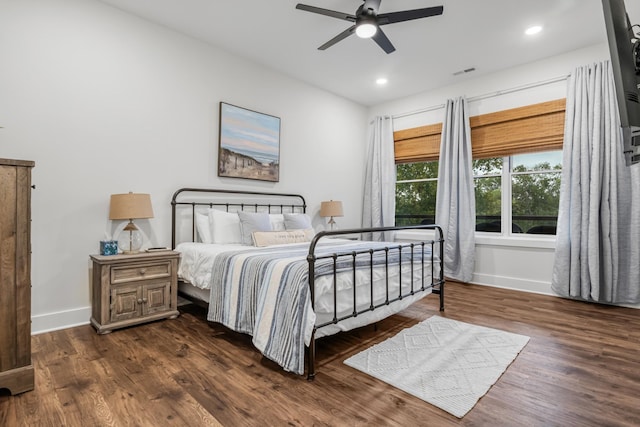 bedroom with dark hardwood / wood-style flooring and ceiling fan