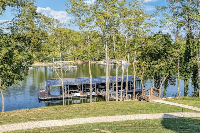 dock area with a yard and a water view