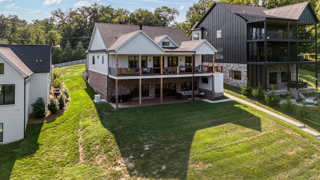 rear view of house with central AC unit, a patio, a balcony, and a yard