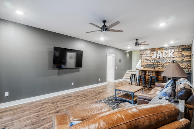 living room featuring ceiling fan and wood-type flooring