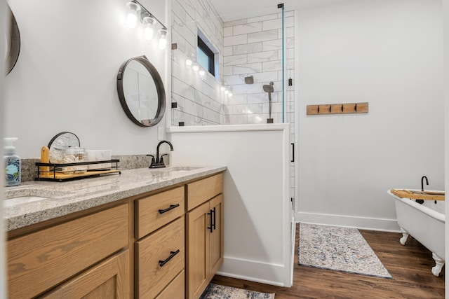 bathroom with hardwood / wood-style flooring, vanity, and independent shower and bath