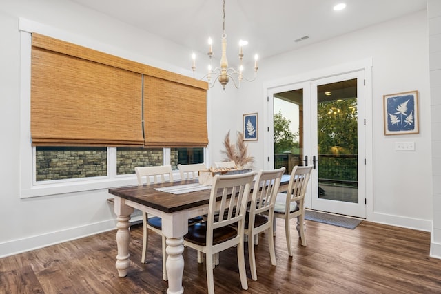 dining room with french doors, dark wood-type flooring, and an inviting chandelier