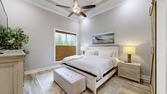 bedroom with light hardwood / wood-style floors, crown molding, and ceiling fan