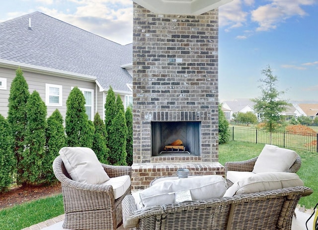 view of patio / terrace featuring an outdoor brick fireplace