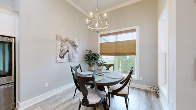 dining area featuring light hardwood / wood-style flooring, a chandelier, and high vaulted ceiling