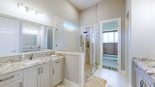 bathroom featuring plenty of natural light, vanity, and tiled shower