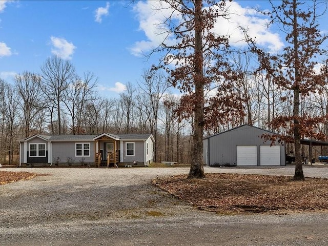 ranch-style home with an outbuilding and a garage