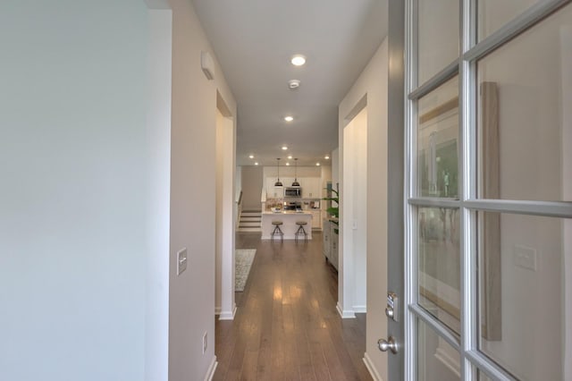 hallway featuring stairway, dark wood-style flooring, and recessed lighting