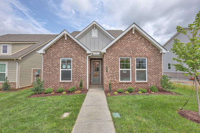 craftsman inspired home with brick siding, board and batten siding, and a front yard