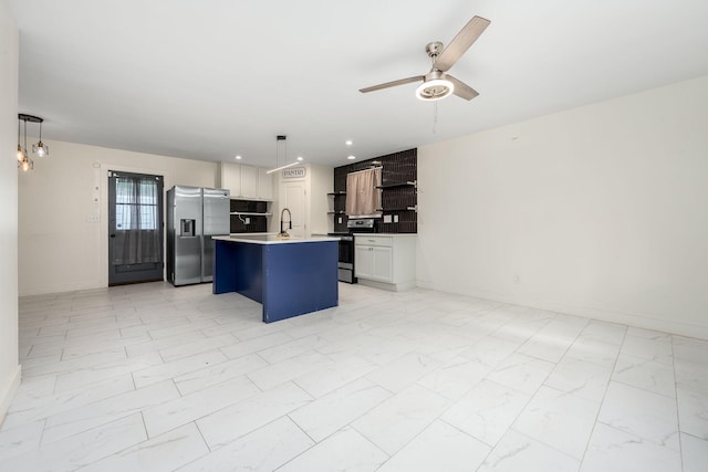 118 Markum Dr, La Vergne, TN 37086 - kitchen with appliances with stainless steel finishes, light marble finish floors, open floor plan, a center island with sink, and a ceiling fan