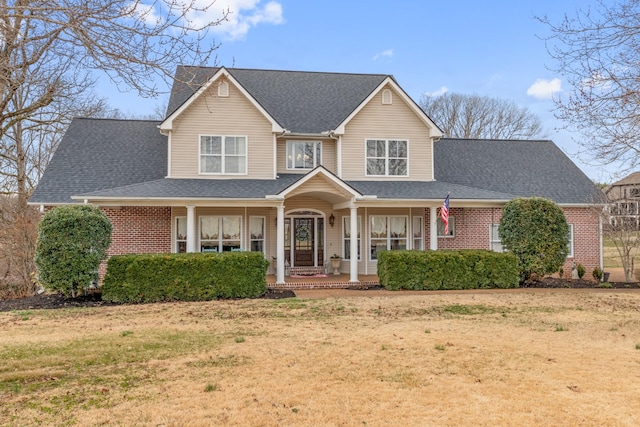 view of front of home with a front yard and a porch