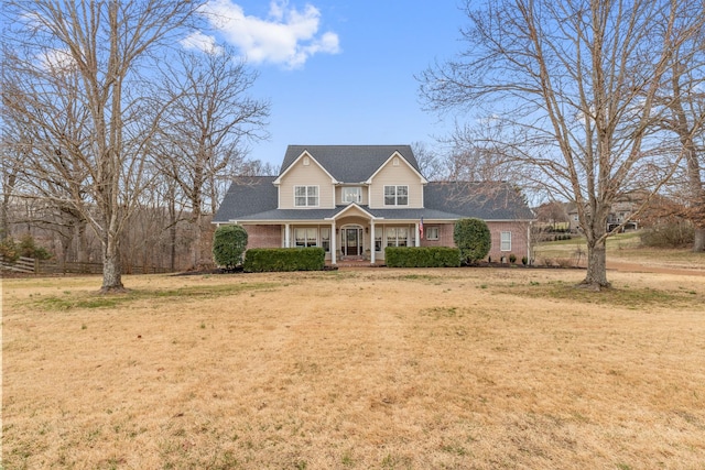 view of front of property with a porch and a front yard