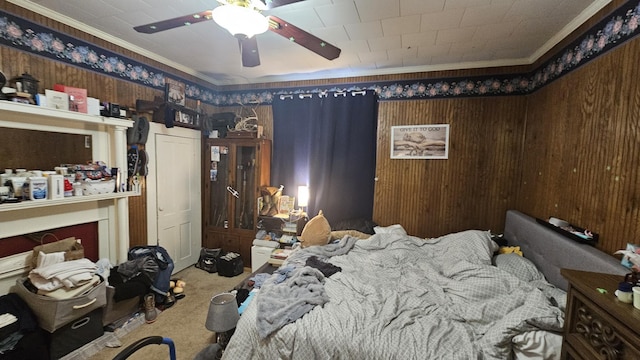 bedroom featuring ceiling fan, ornamental molding, and carpet flooring