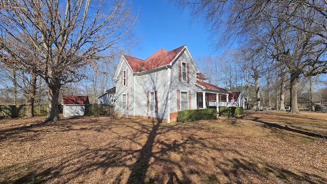 view of property exterior featuring a yard and a storage shed