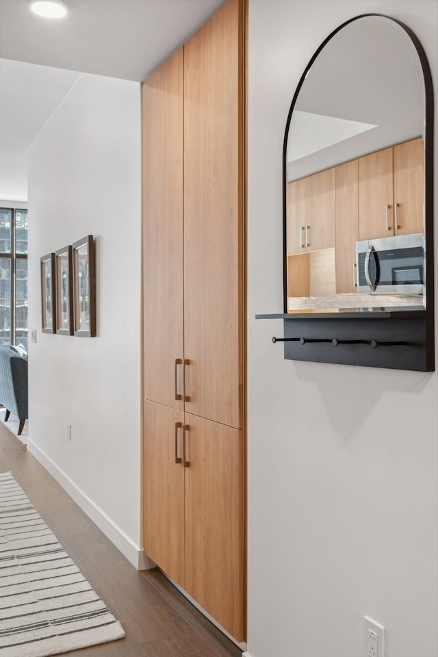 interior space featuring dark wood-style floors and baseboards