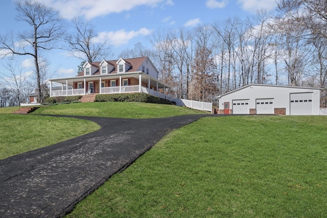 farmhouse featuring covered porch, a garage, and a front lawn