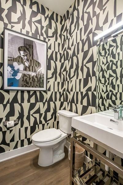 bathroom with hardwood / wood-style flooring and toilet