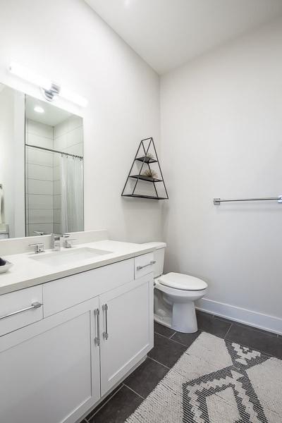 bathroom with tile patterned floors, toilet, vanity, and a shower with shower curtain