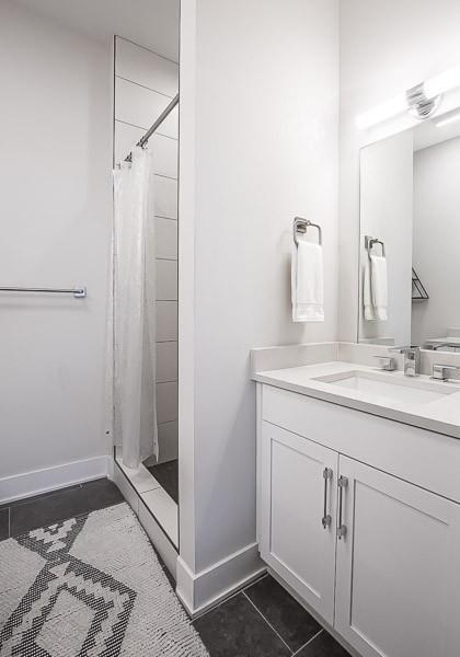 bathroom featuring tile patterned flooring, vanity, and walk in shower