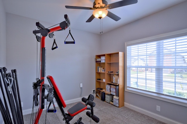 exercise area featuring light colored carpet and ceiling fan