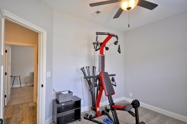 exercise room with hardwood / wood-style floors and ceiling fan