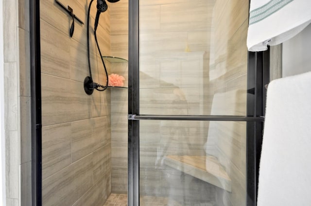 bathroom featuring a shower with shower door