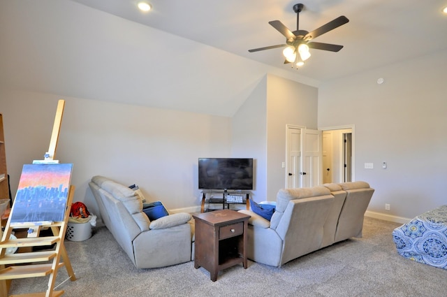 living room with ceiling fan, vaulted ceiling, and carpet floors