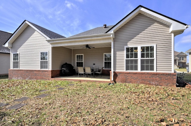 rear view of property featuring ceiling fan and a patio area