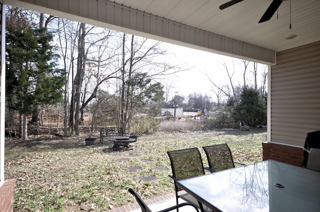 view of patio with ceiling fan and a fire pit