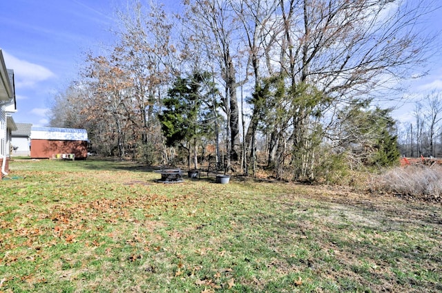 view of yard with an outdoor fire pit