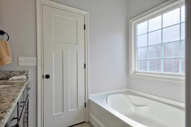 bathroom featuring vanity and a bath