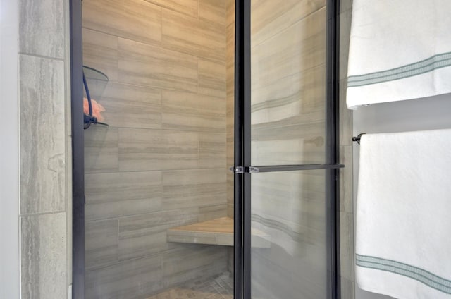 bathroom with a shower with door
