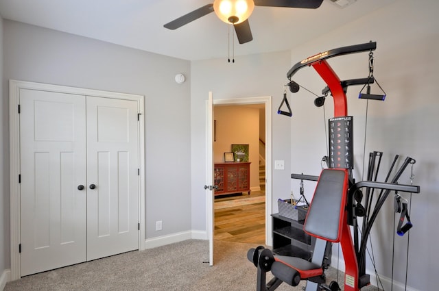 workout room with ceiling fan and carpet floors