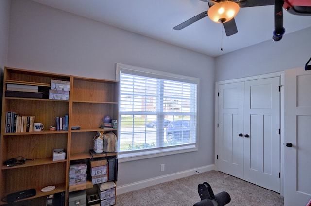 workout area with light carpet and ceiling fan
