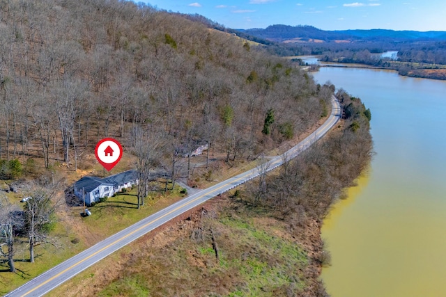 drone / aerial view featuring a water and mountain view