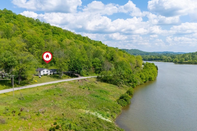 aerial view featuring a water view and a wooded view