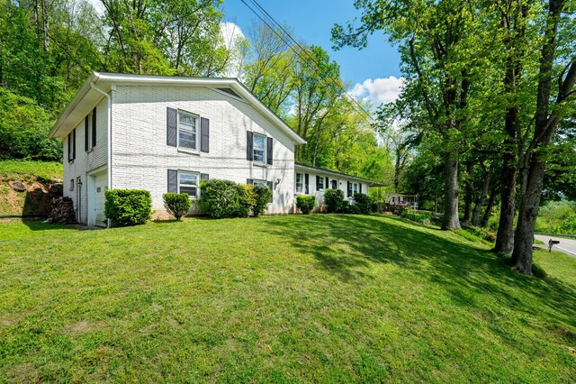 view of property exterior with a garage and a yard