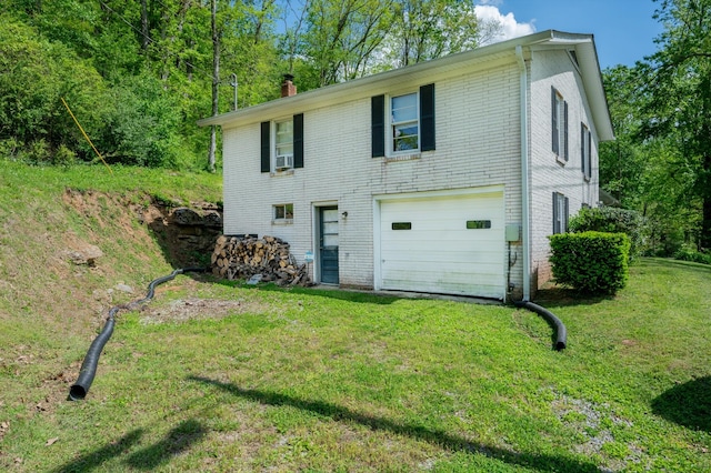 exterior space featuring an attached garage, a chimney, cooling unit, a lawn, and driveway