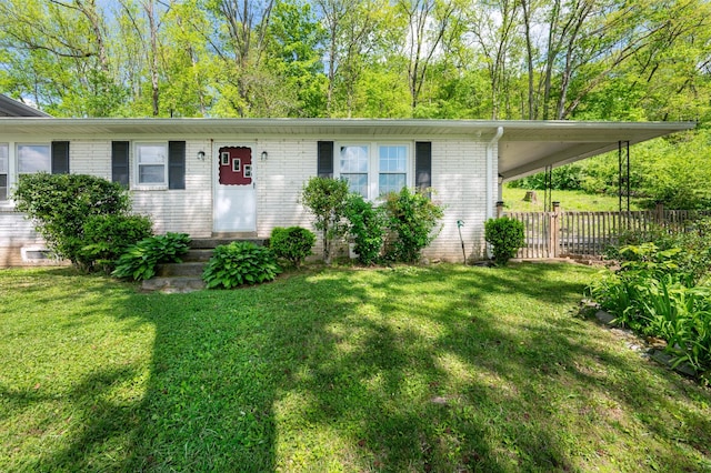 single story home featuring fence, a front lawn, and brick siding