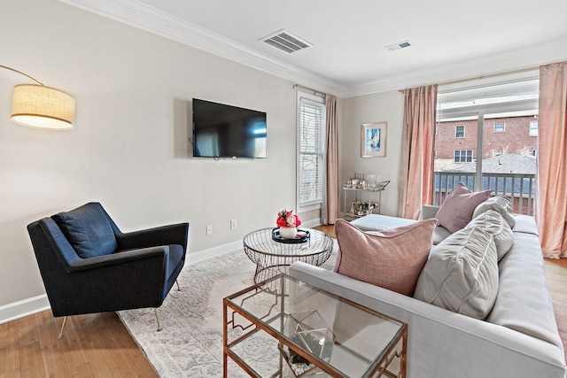 living room featuring ornamental molding and wood-type flooring